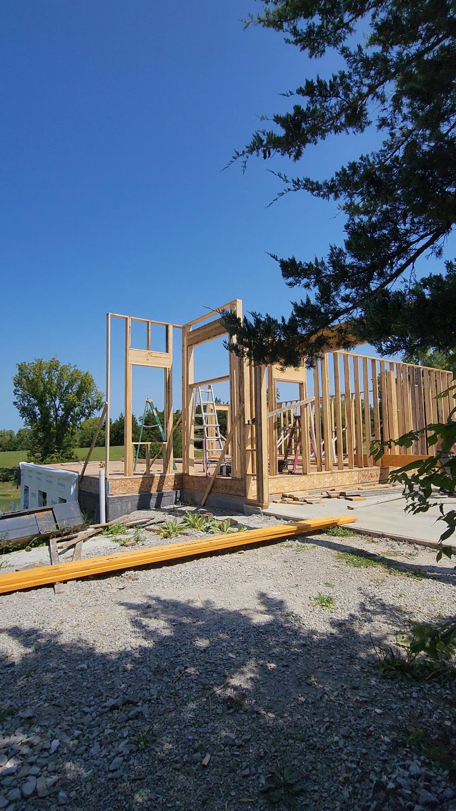 Wall framing with door and window openings and headers on a new foundation