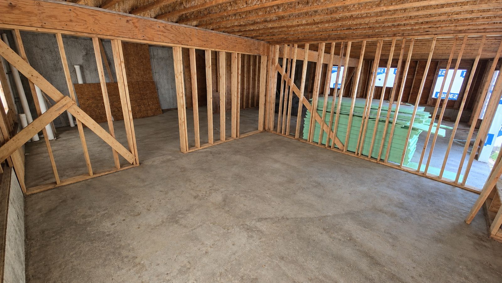 Interior wall framing with bracing on a concrete slab
